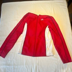 Red and white Nike Sportswear windbreaker with hood.